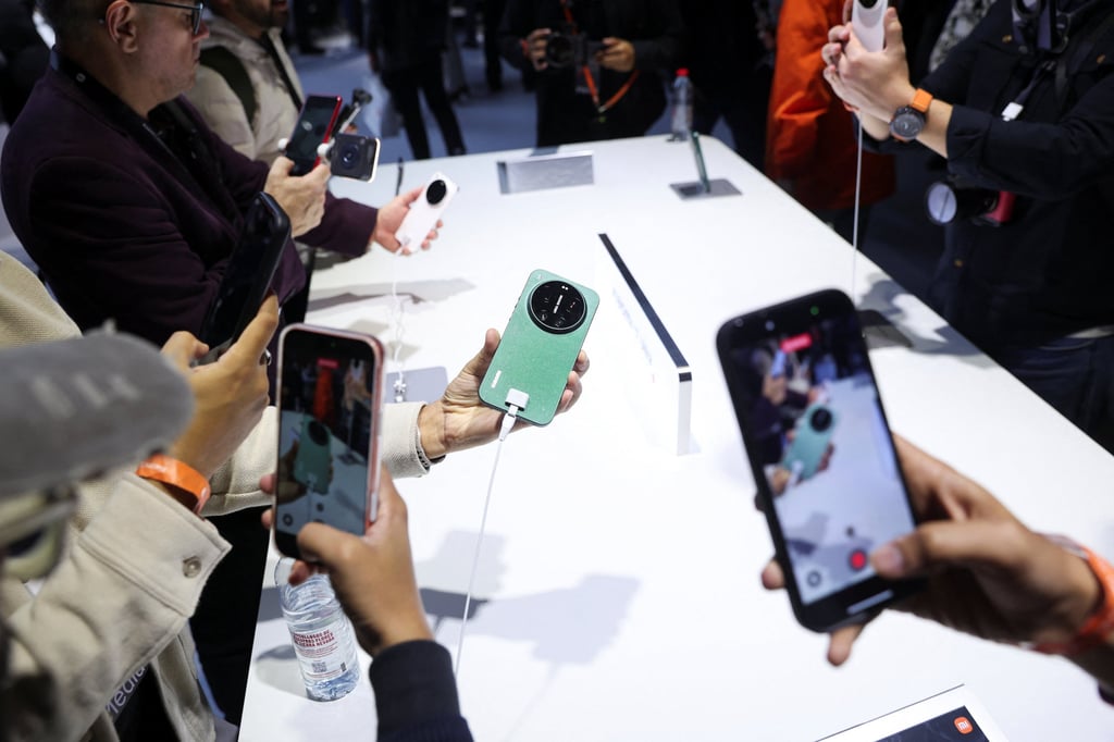 People test the latest Xiaomi smartphone models ahead of the Mobile World Congress in Barcelona, Spain. Photo: Reuters People test the latest Xiaomi smartphone models ahead of the Mobile World Congress in Barcelona, Spain. Photo: Reuters